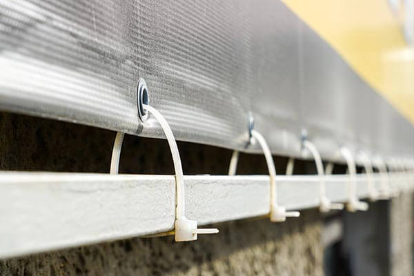 Large format printed PVC banner with secure fittings for outdoor use.